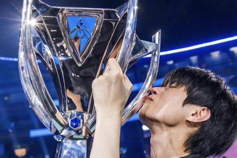 Deft embracing his first Worlds trophy.