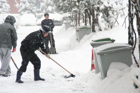 South Korean citizens sweeping snow in freezing weather