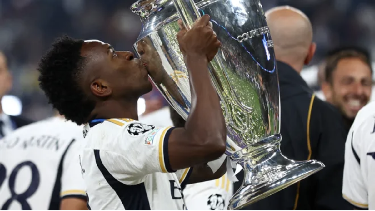 Vinicius Junior, a player from the 2024 UEFA Champions League champions Real Madrid, celebrating their victory with the trophy.