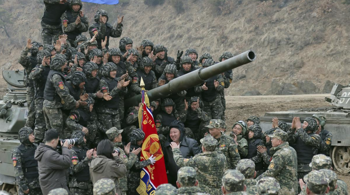 North Korean soldiers rally around a tank during a military drill with King Jong Un
