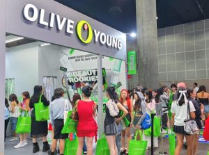 Visitors explore Olive Young's booth at KCON LA 2024