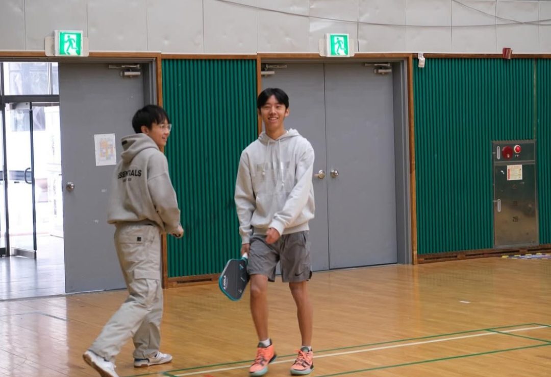 Brian Ji (11) playing a pickleball match.