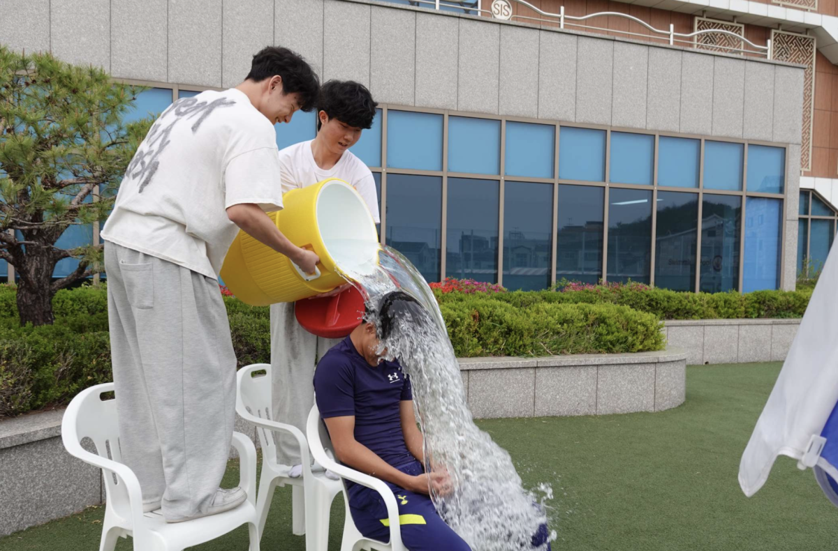 Ryan Kim (11), getting dumped with water