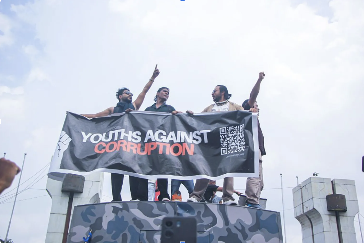 Protesters hold up a flier with the slogan “Youths Against Corruption.”