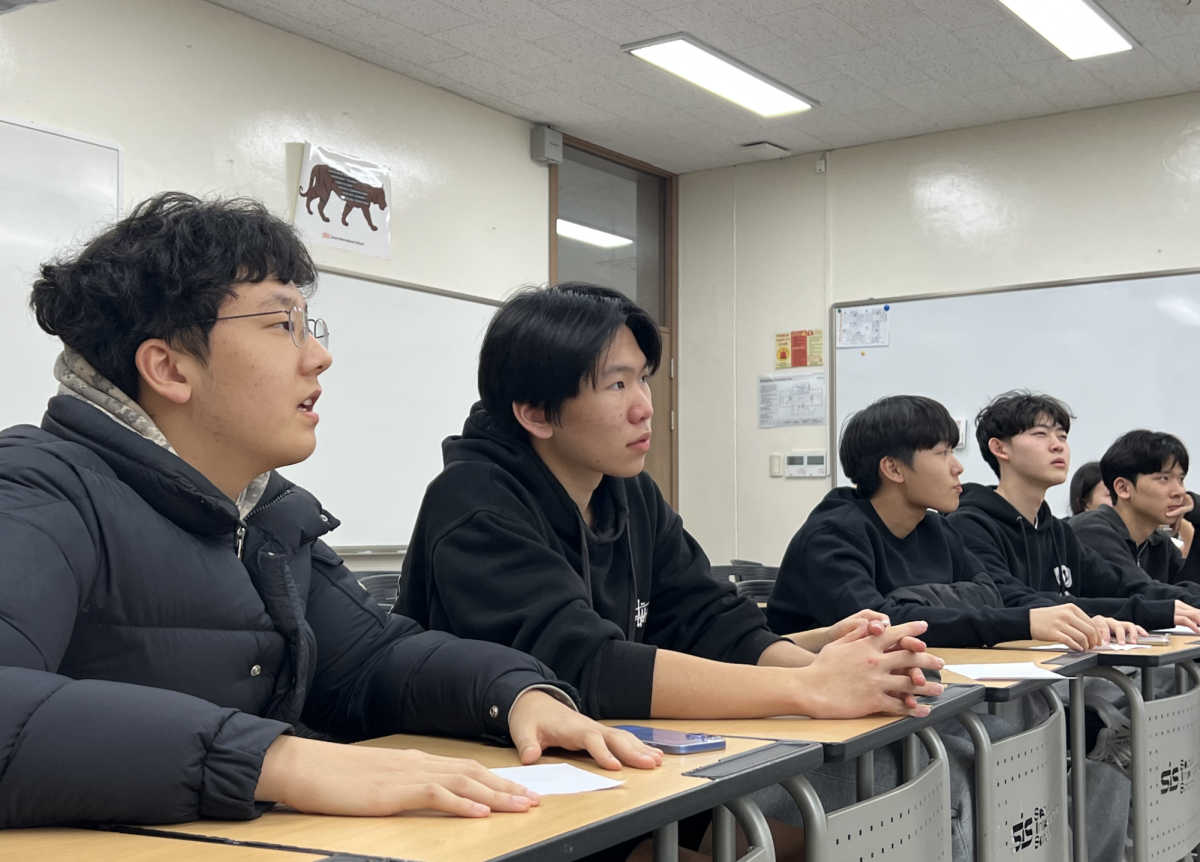 Students listen to a lecture during a club meeting

