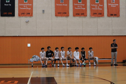 SIS Varsity Volleyball Bench members eagerly watch their teammates perform.