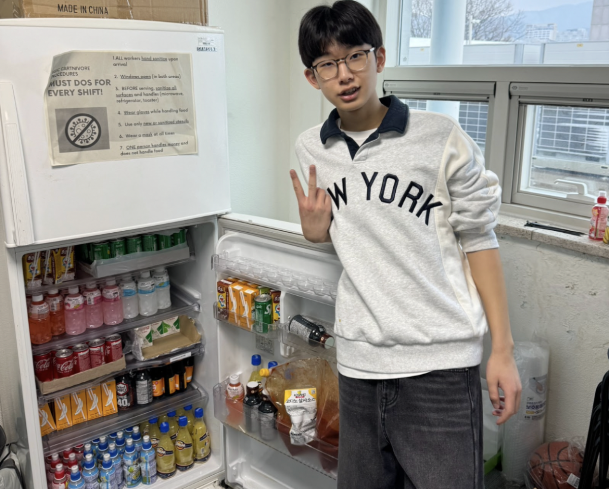 Jason Kang (11), HSSC Public Relations, poses after dedicating after-school time setting up the Snack Shack for NHD.