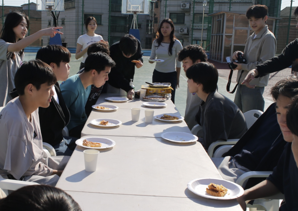 Pi Day event attendees participate in a pie-eating contest