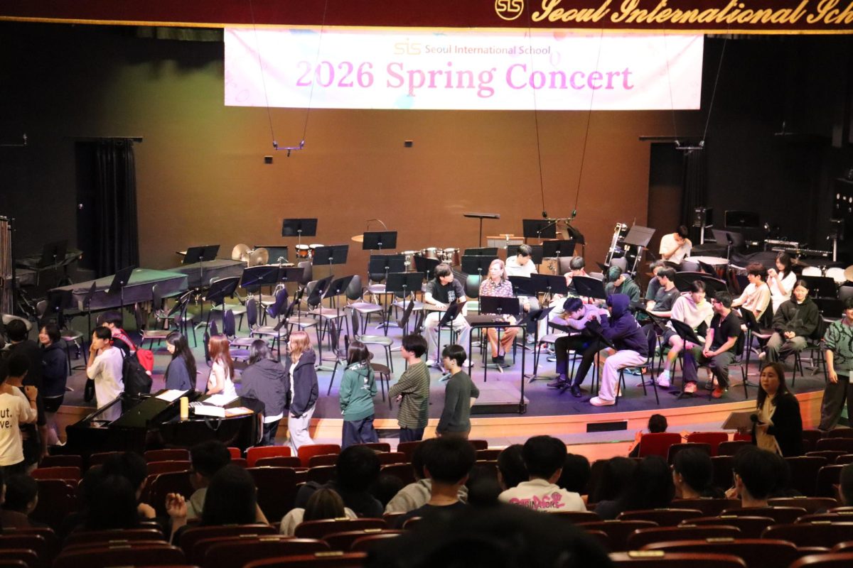 Strings and band students rehearse for the spring concert