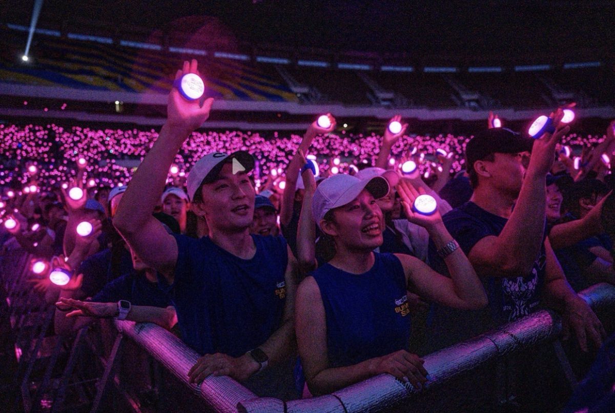 Fans cheering at a K-pop concert