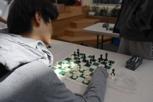Participants face off against each other in a competitive chess game